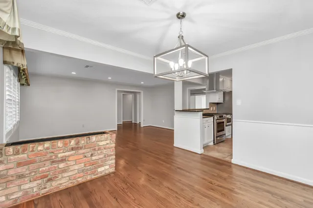a view of a kitchen with a stove cabinets and a wooden floor