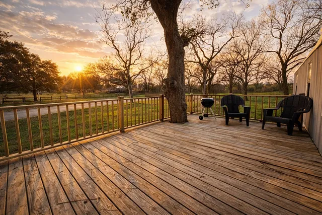 a view of a wooden deck with trees