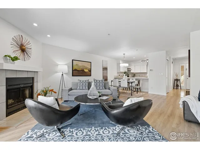 a living room with furniture a fireplace and a table