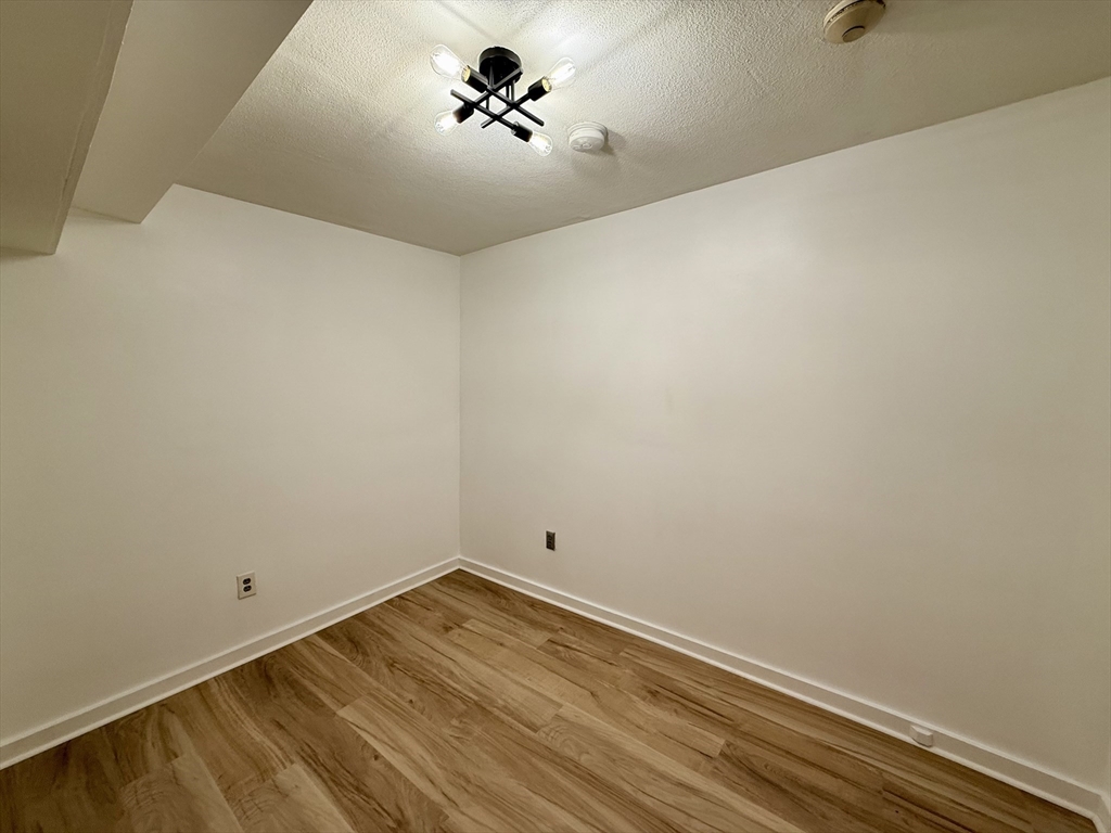 28 Ransom Road, Unit 12AB Boston, MA 02135 - Photo 14 of 17 a view of a room with wooden floor