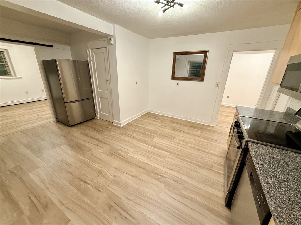 28 Ransom Road, Unit 12AB Boston, MA 02135 - Photo 5 of 17 a view of a livingroom with wooden floor and staircase