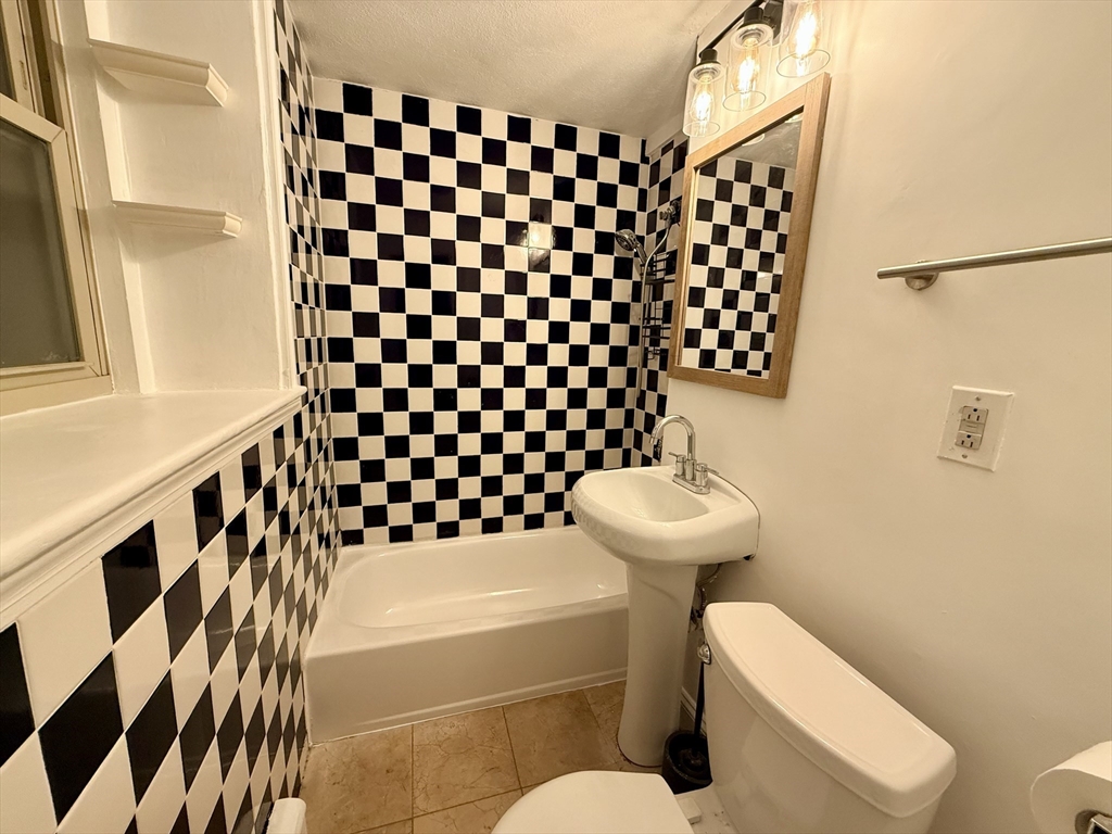 28 Ransom Road, Unit 12AB Boston, MA 02135 - Photo 6 of 17 a bathroom with a sink toilet and shower
