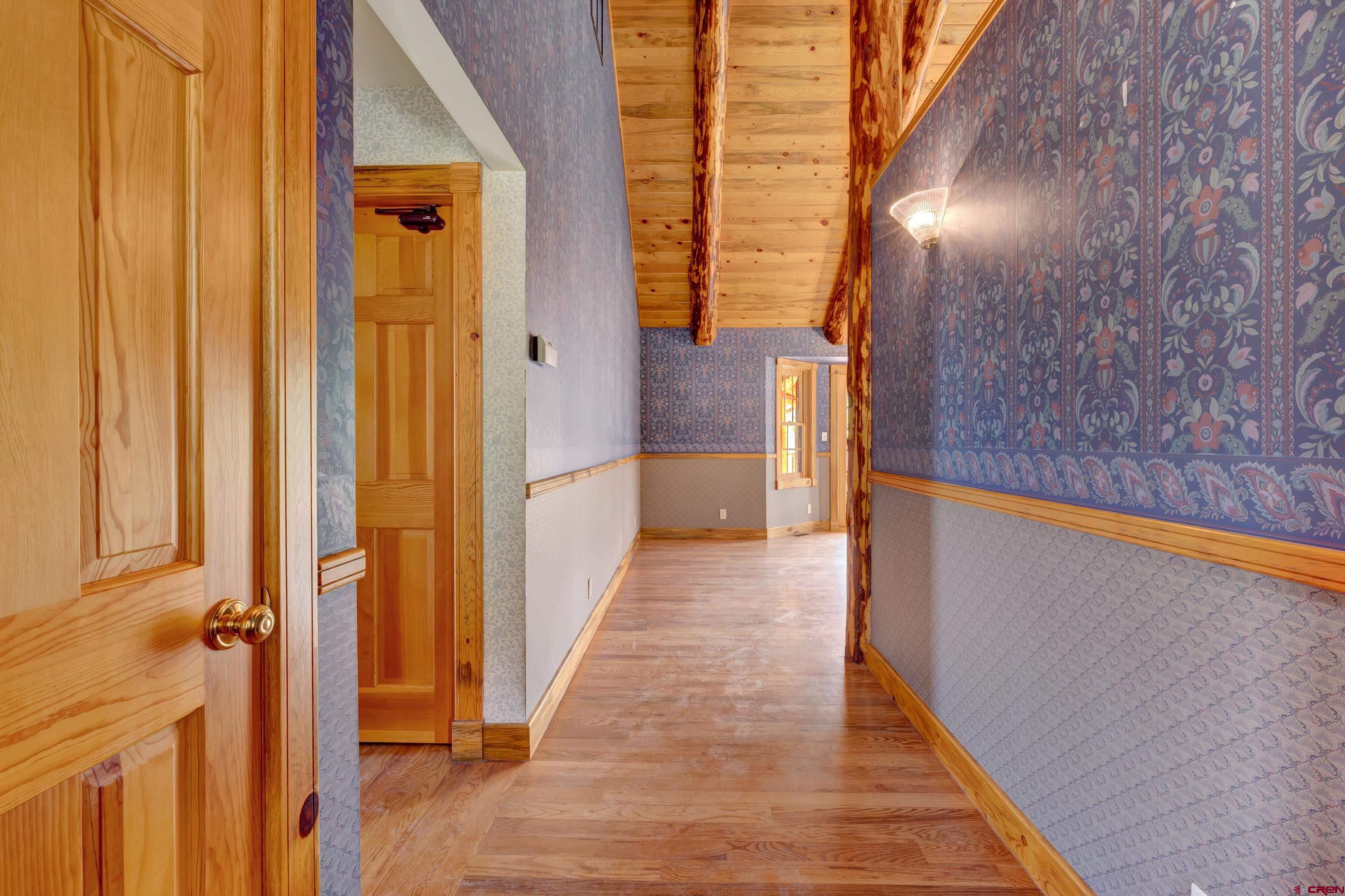 2692 County Road 17 Ridgway, CO 81432 - Photo 4 of 38 a view of a hallway with wooden floor and staircase
