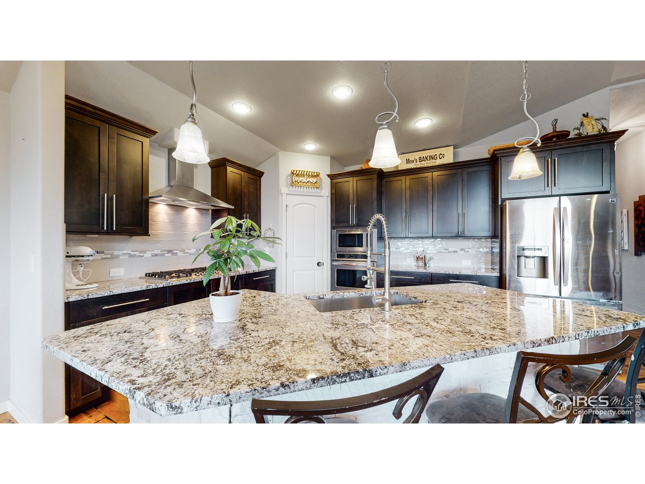 Spacious pantry, undermount sink, crown molding on cabinets, tile backsplash with accent