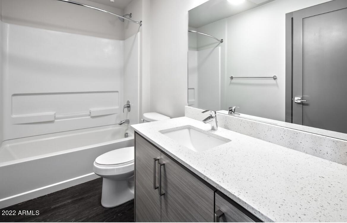 425 West Osborn Road, Unit 406 Phoenix, AZ 85013 - Photo 8 of 24 a bathroom with a sink toilet and shower