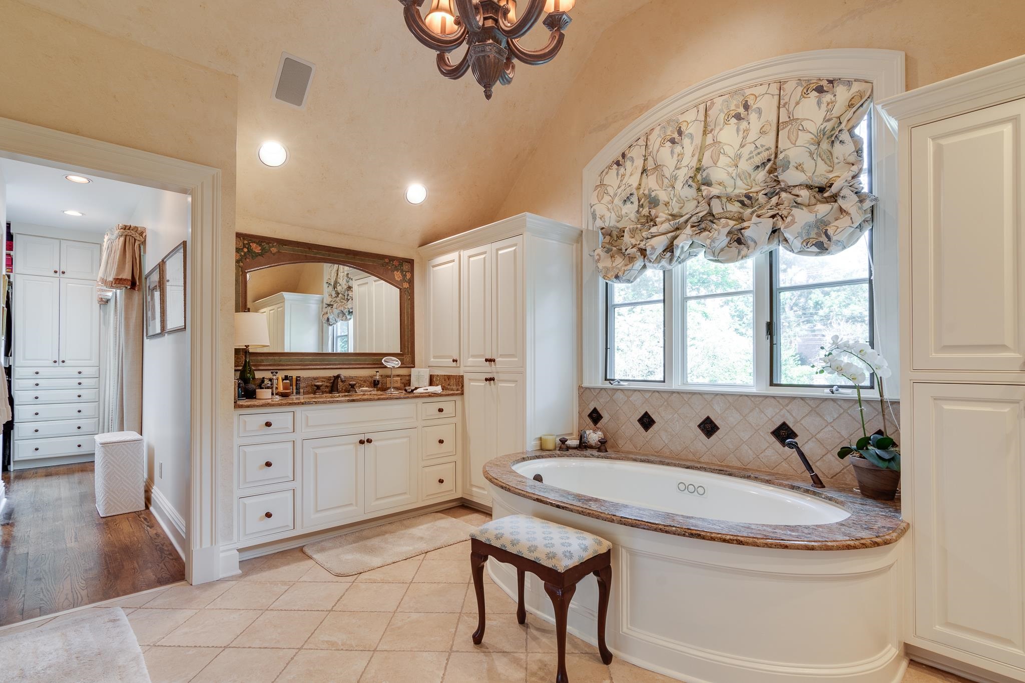 54 South Rose Road Memphis, TN 38117 - Photo 38 of 40 a bathroom with a granite countertop sink a large mirror and a bathtub