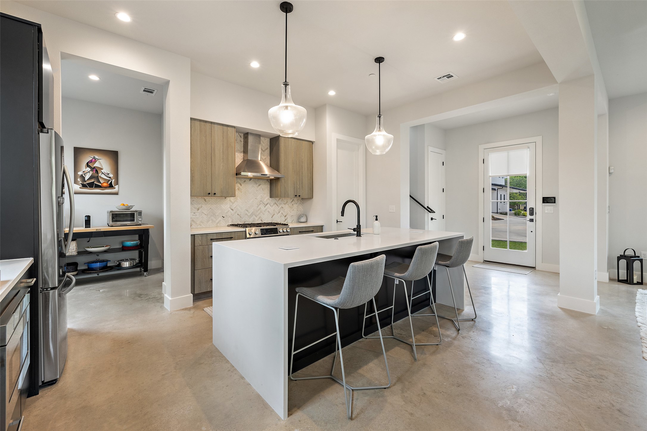 1504 Ruth Avenue, Unit 3 Austin, TX 78757 - Photo 11 of 39 Culinary adventures await in this kitchen, boasting an expansive island with breakfast bar seating.