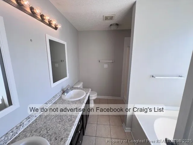 a bathroom with a sink a toilet and a shower