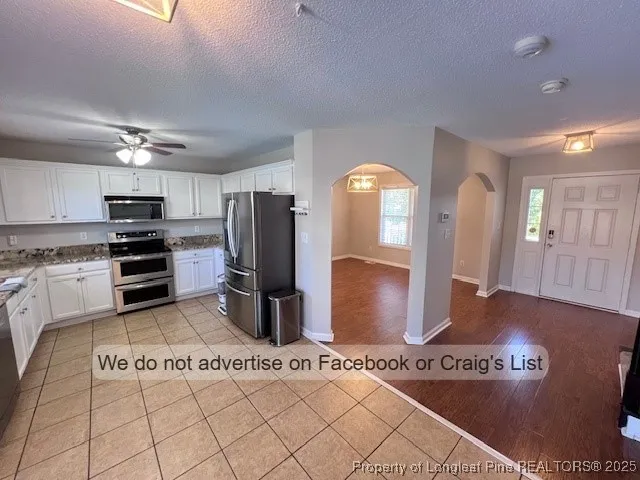 a kitchen with stainless steel appliances granite countertop a refrigerator and a stove