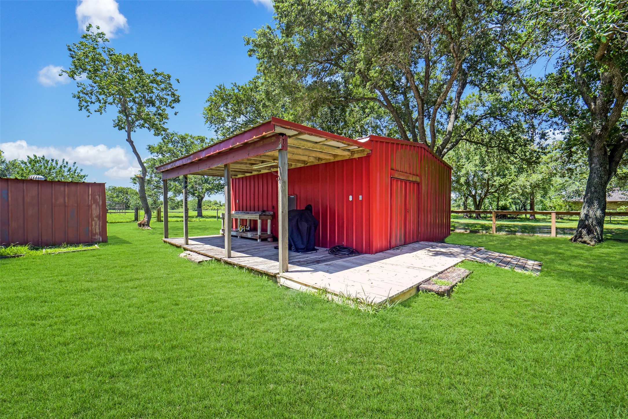 9606 Needville Fairchilds Road Needville, TX 77461 - Photo 40 of 46 a view of a wooden deck and a yard with green space