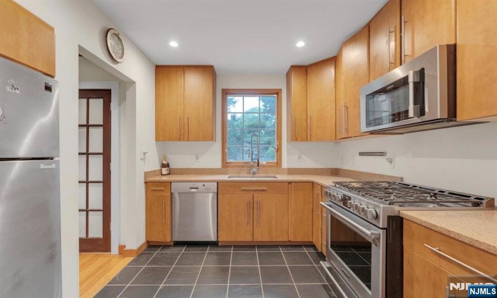 278 Maple Street Haworth, NJ 07641 - Photo 16 of 37 a kitchen with stainless steel appliances granite countertop a stove a sink and a refrigerator