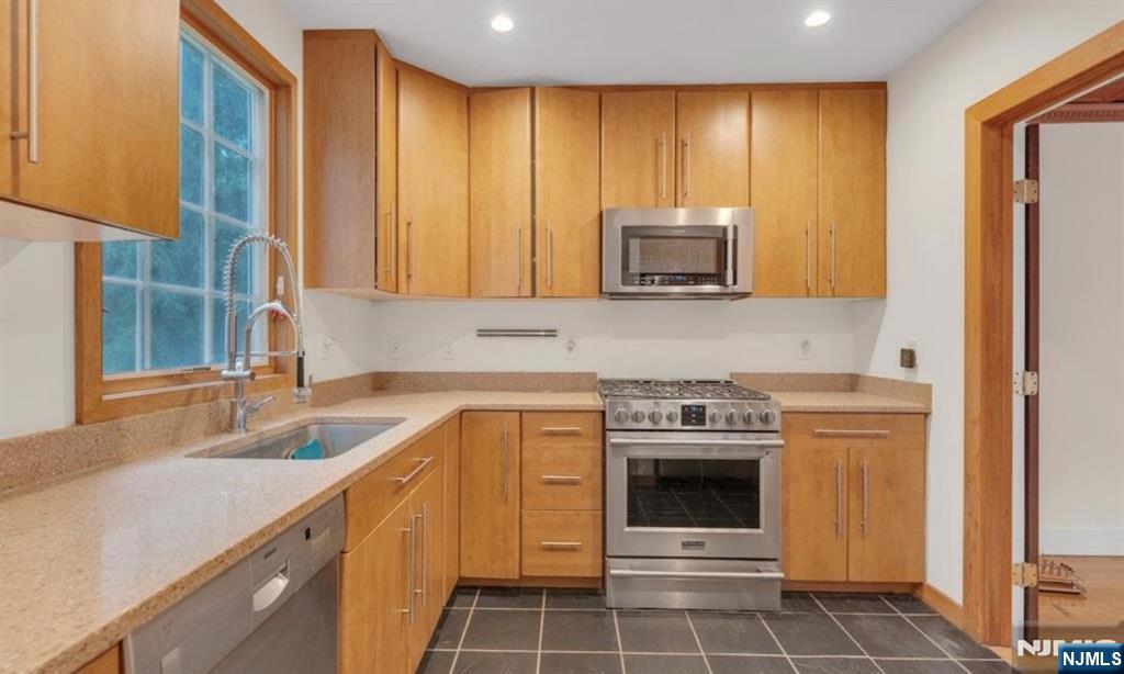 278 Maple Street Haworth, NJ 07641 - Photo 17 of 37 a kitchen with a stove a sink and a microwave
