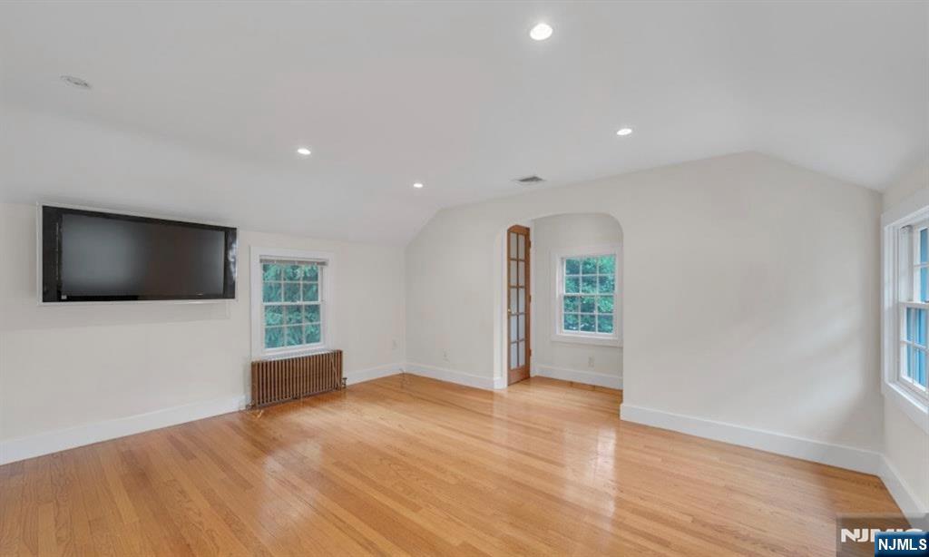 278 Maple Street Haworth, NJ 07641 - Photo 20 of 37 a view of a livingroom with wooden floor and a flat screen tv