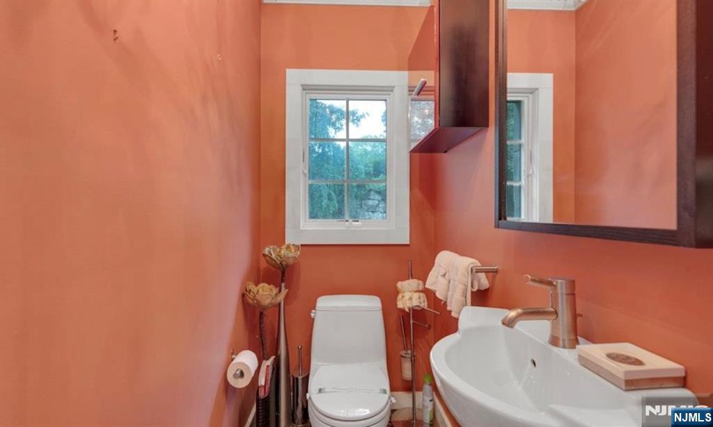 278 Maple Street Haworth, NJ 07641 - Photo 28 of 37 a bathroom with a toilet sink and mirror