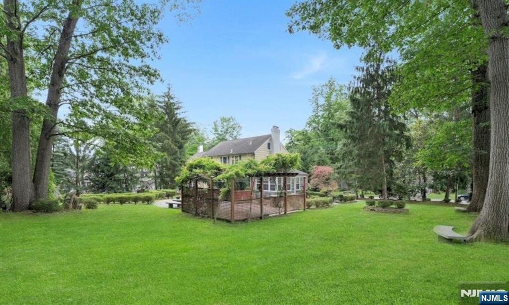 278 Maple Street Haworth, NJ 07641 - Photo 30 of 37 a view of a garden with a bench in the park