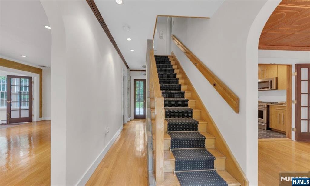 278 Maple Street Haworth, NJ 07641 - Photo 3 of 37 a view of staircase with lots of frames on wall and wooden floor