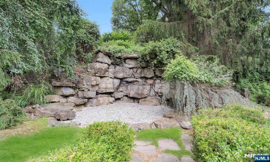 278 Maple Street Haworth, NJ 07641 - Photo 34 of 37 a view of a yard with plants and large trees