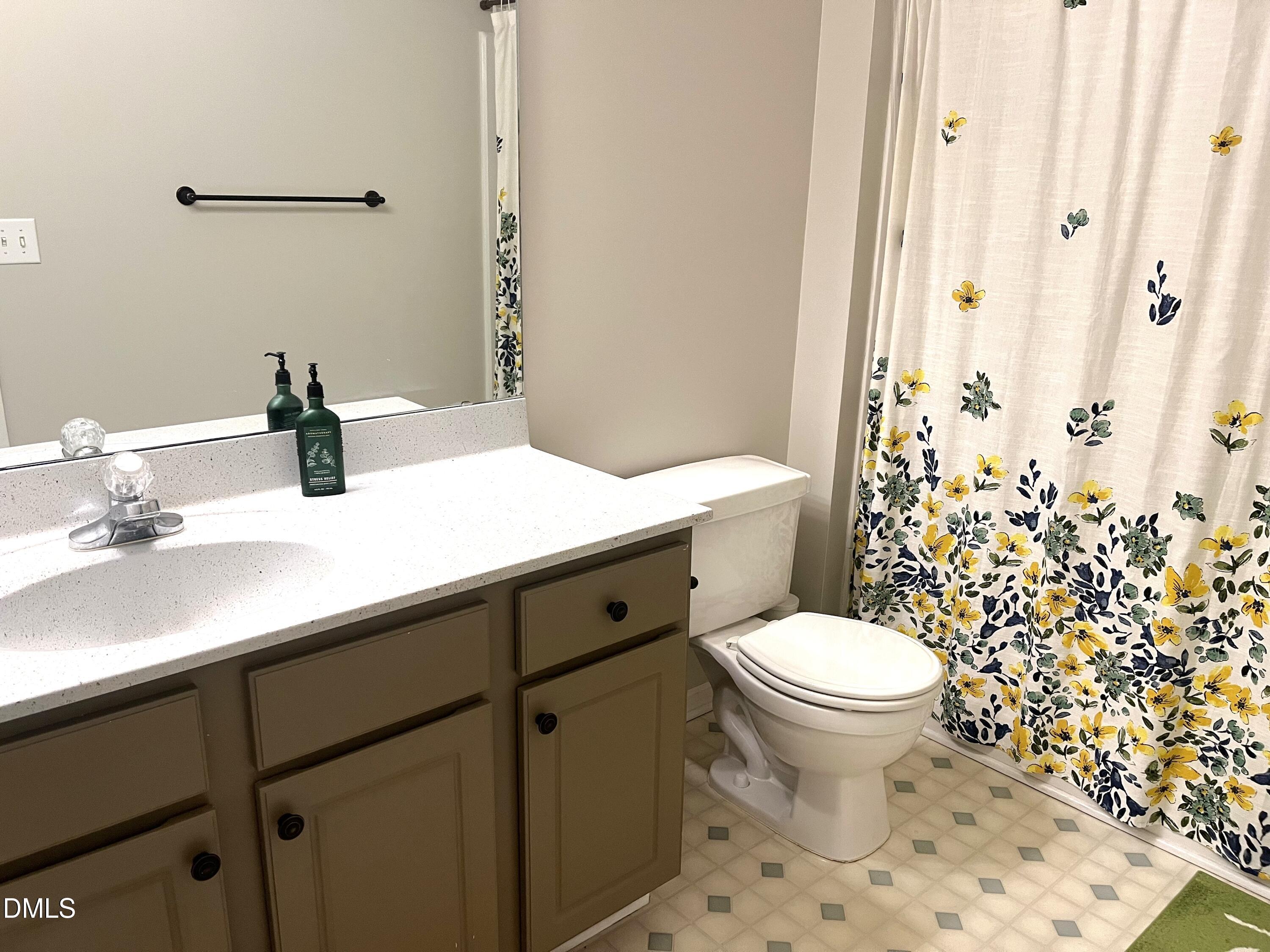 4307 Southwind Drive Raleigh, NC 27613 - Photo 13 of 15 a bathroom with a sink toilet and shower