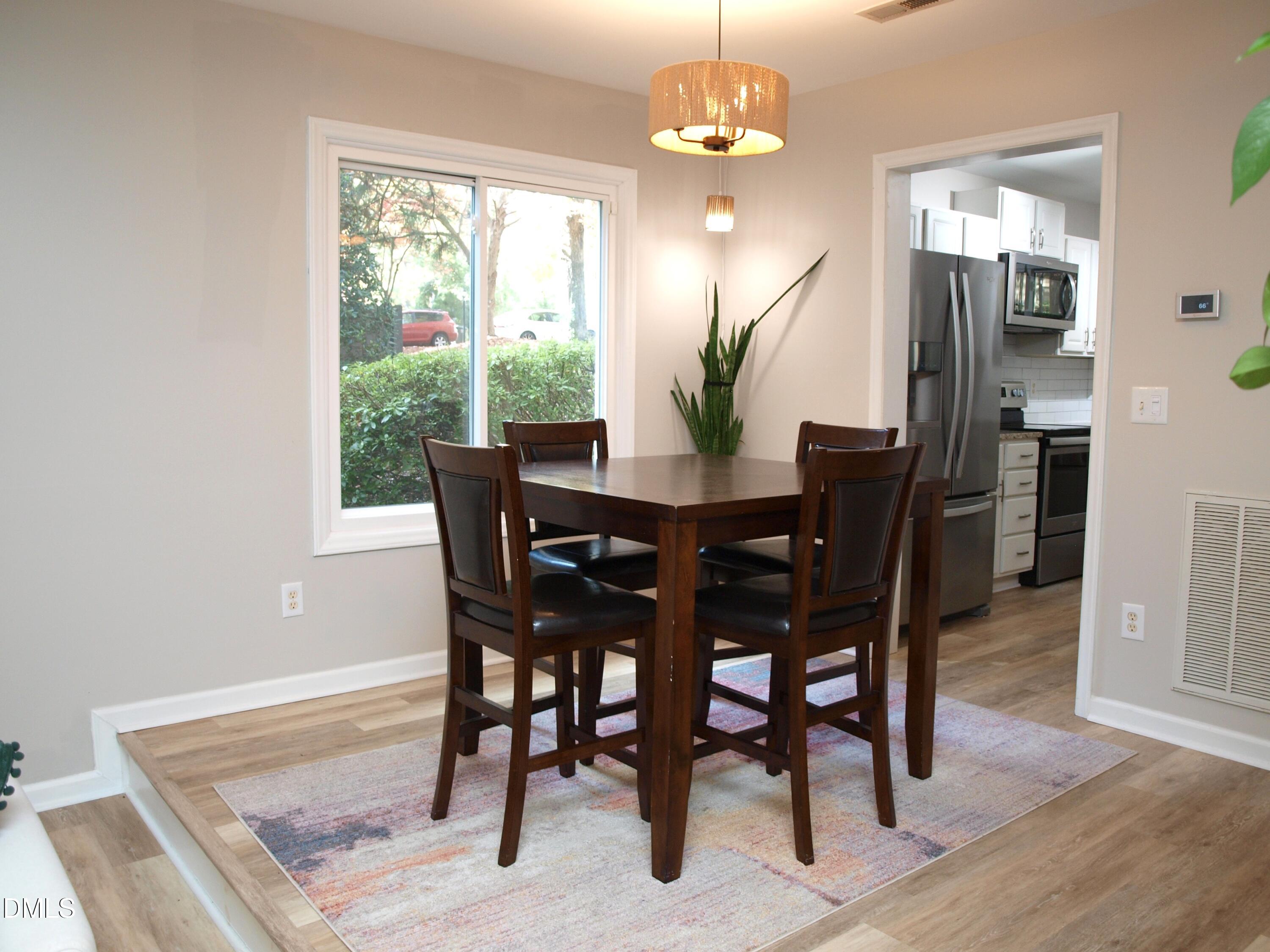 4307 Southwind Drive Raleigh, NC 27613 - Photo 3 of 15 a view of a dining room with furniture window and wooden floor