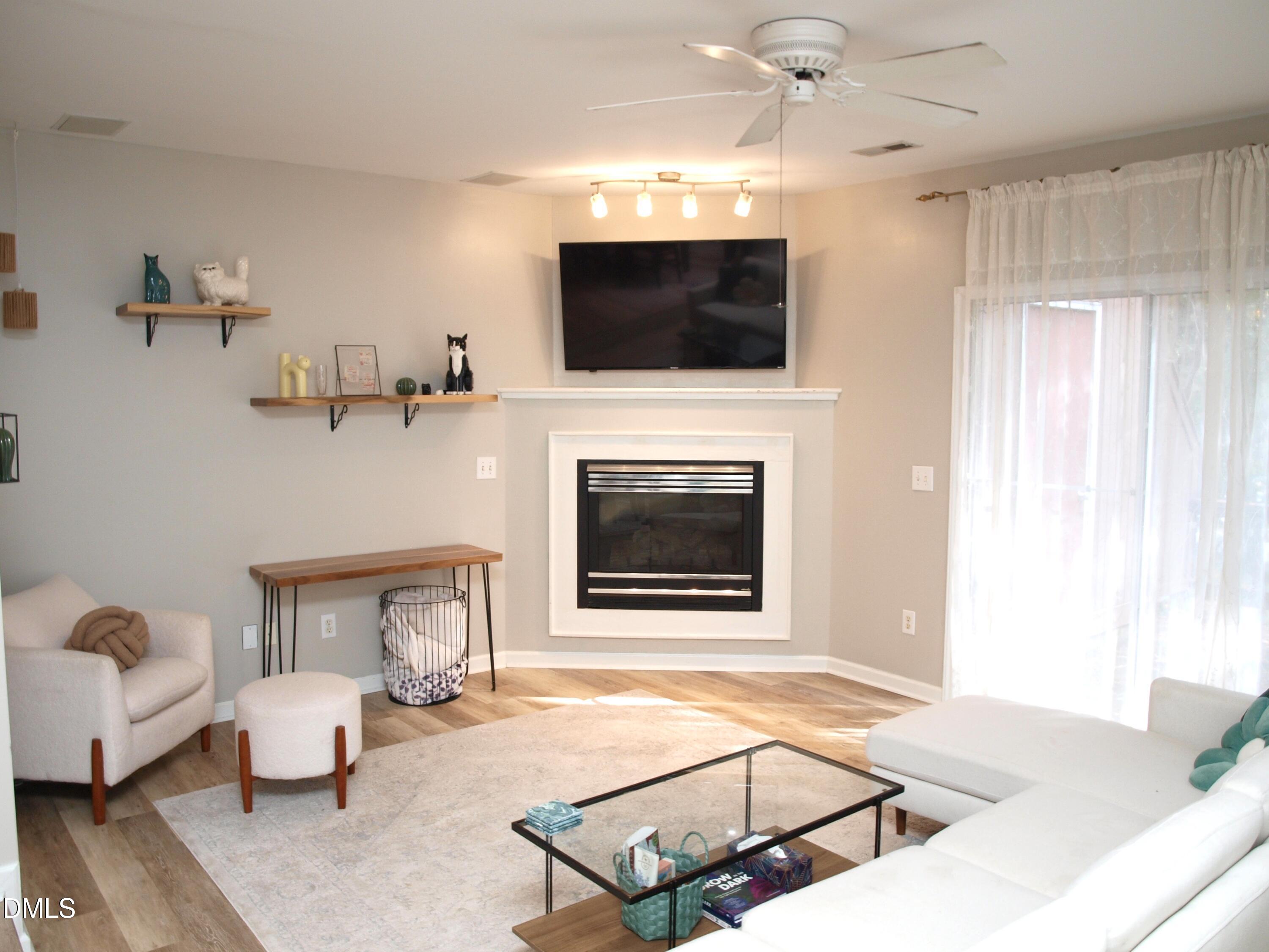4307 Southwind Drive Raleigh, NC 27613 - Photo 4 of 15 a living room with furniture and a fireplace