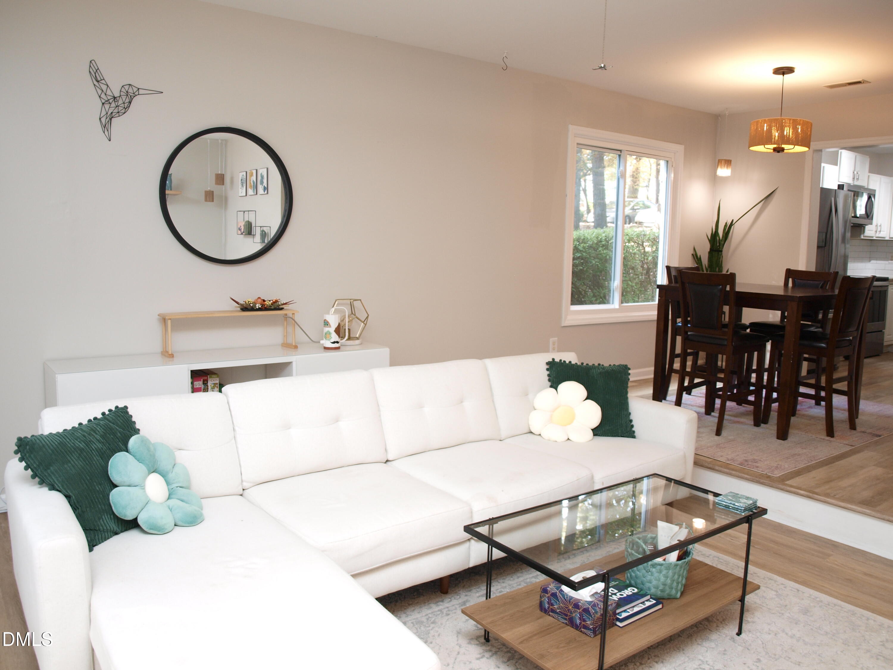 4307 Southwind Drive Raleigh, NC 27613 - Photo 5 of 15 a living room with furniture a window and a clock