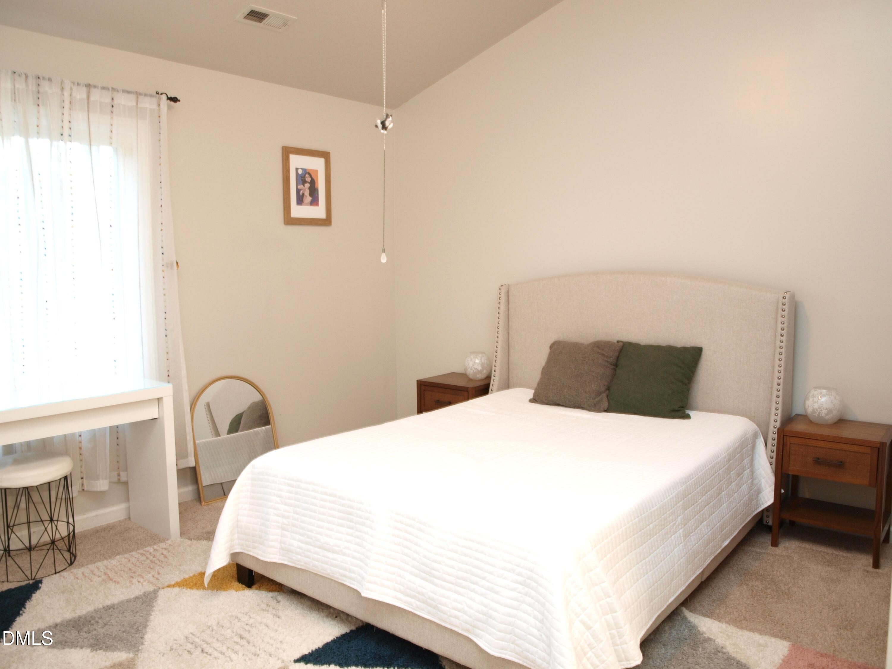 4307 Southwind Drive Raleigh, NC 27613 - Photo 9 of 15 a bedroom with a bed and a window