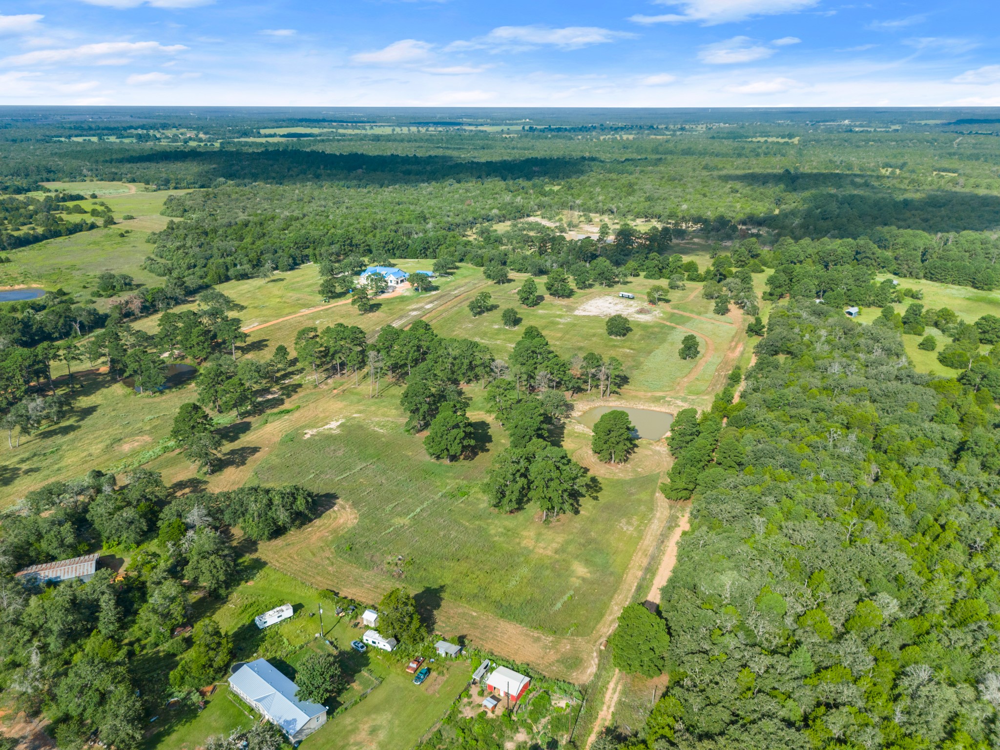 170 Split Oak Road Smithville, TX 78957 - Photo 21 of 31 Sprawling acreage offers a secluded home, ample green space, and natural ponds for serene country living.