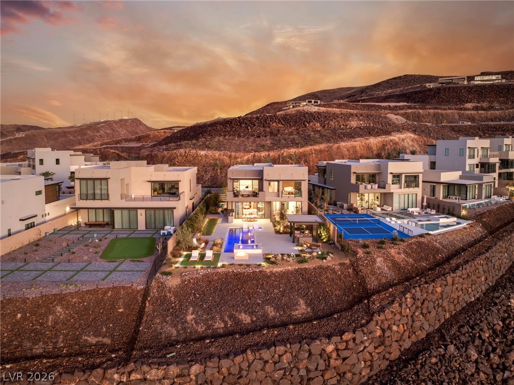 571 Overlook Rim Drive Henderson, NV 89012 - Photo 78 of 85 Rear view of house with a patio, a pool, and a mountain view