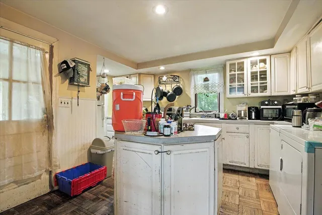 a kitchen with a sink cabinets and window