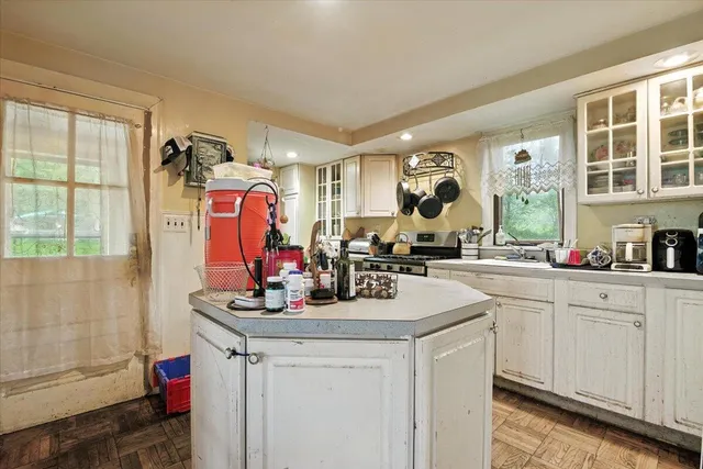a kitchen with stainless steel appliances granite countertop a stove and a sink
