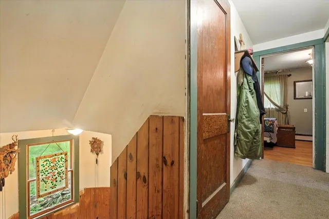 a bed sitting in a bedroom next to a window