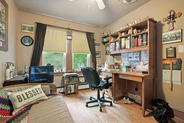 a bedroom with a bed next to a window