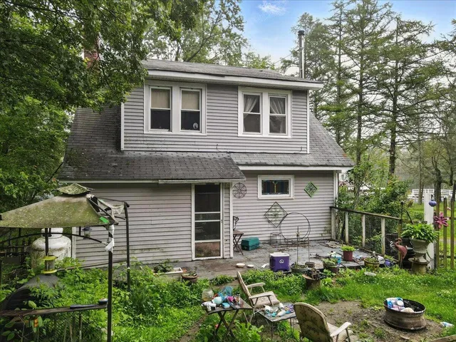a view of a table and chairs in a garden
