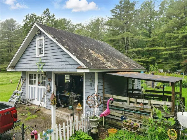 an aerial view of a house with pool yard and outdoor seating