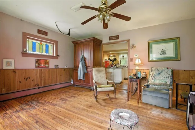 a living room with furniture a flat screen tv and a large window