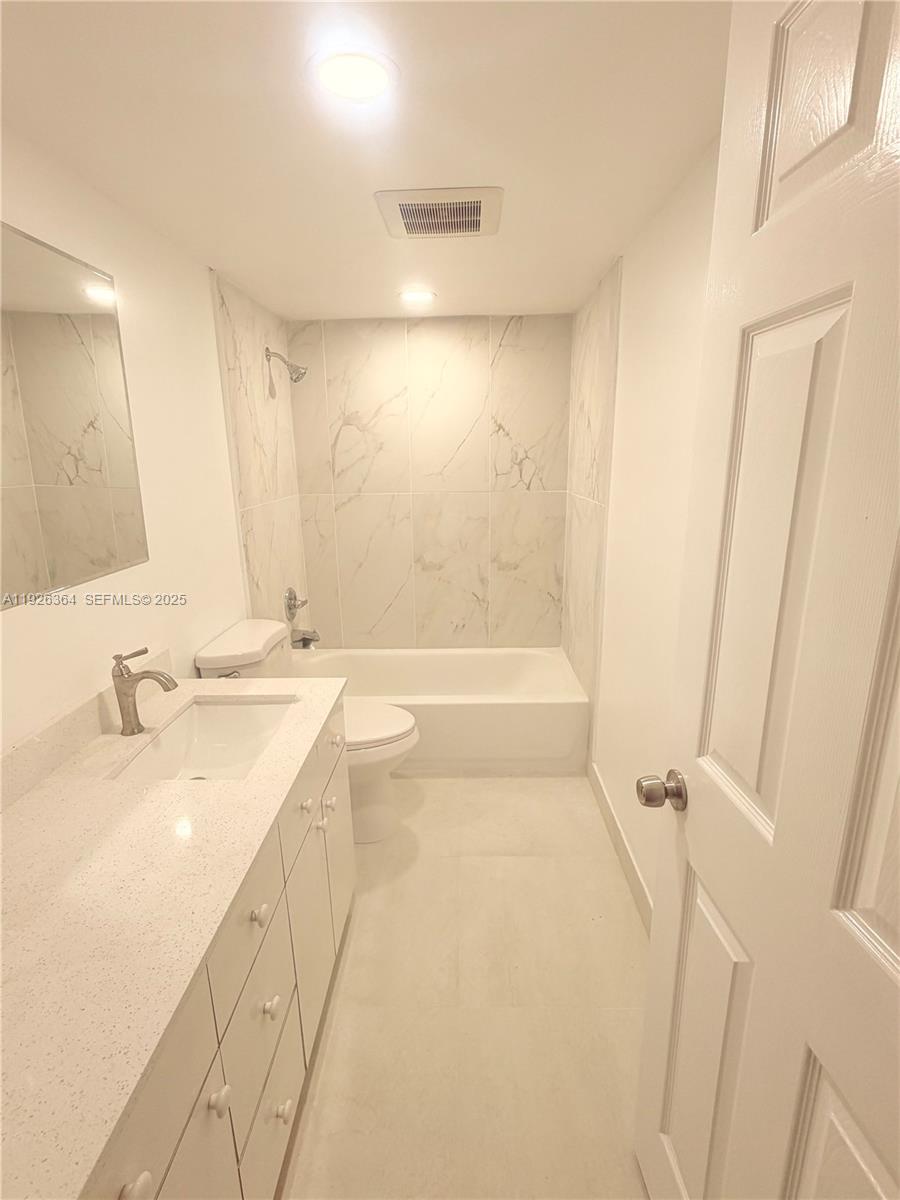 7208 Fairway Drive, Unit I20 Miami Lakes, FL 33014 - Photo 13 of 22 a bathroom with a tub sink and mirror