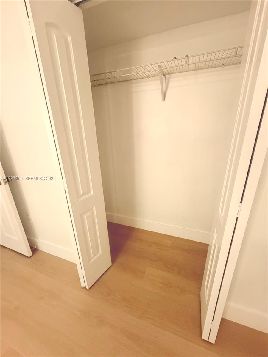 7208 Fairway Drive, Unit I20 Miami Lakes, FL 33014 - Photo 17 of 22 a view of walk in closet with clothes