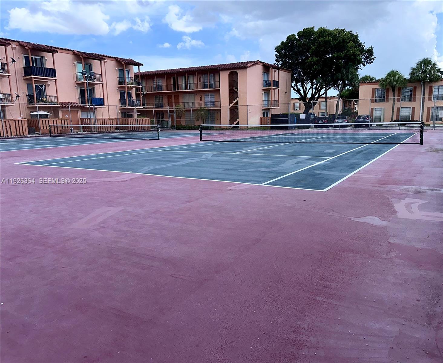 7208 Fairway Drive, Unit I20 Miami Lakes, FL 33014 - Photo 19 of 22 a view of a house with a large space and large trees