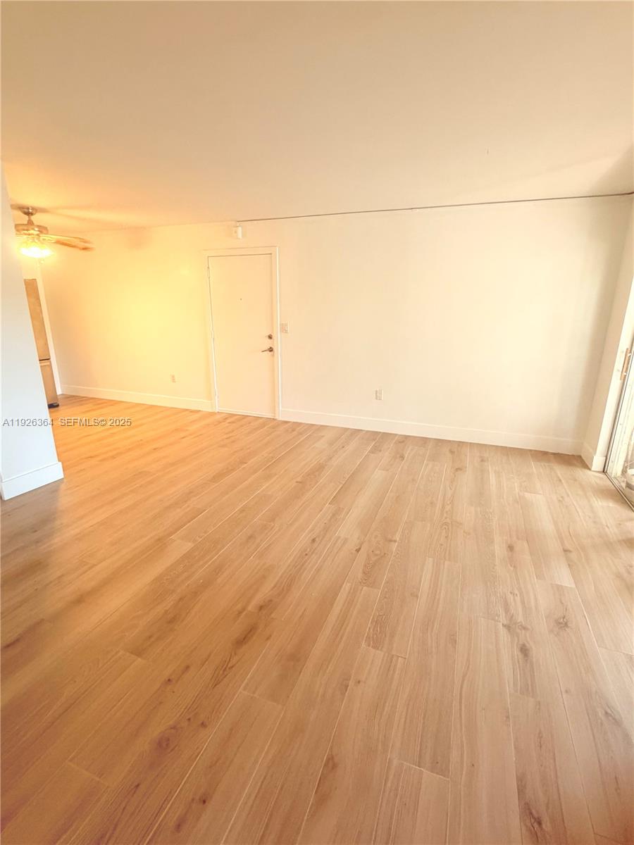 7208 Fairway Drive, Unit I20 Miami Lakes, FL 33014 - Photo 4 of 22 a view of empty room with wooden floor