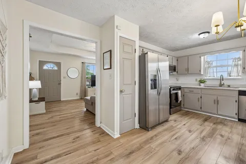 a kitchen with stainless steel appliances a refrigerator sink and cabinets