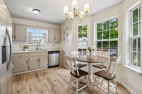 a kitchen with a table chairs stove and cabinets
