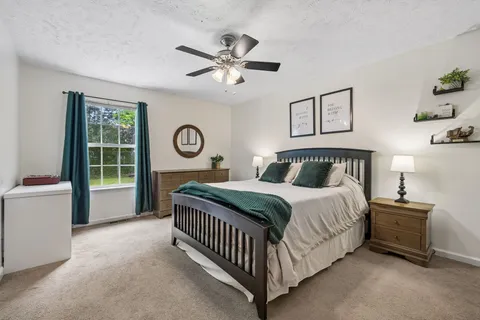 a bedroom with a bed and a window