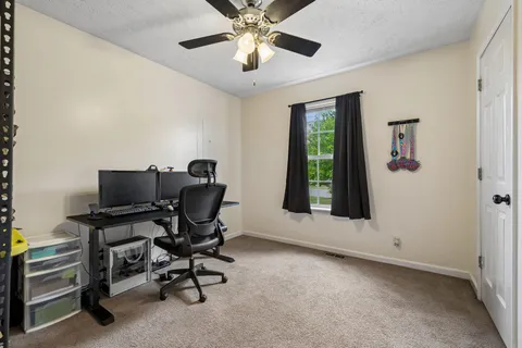 a workspace with chandelier fan
