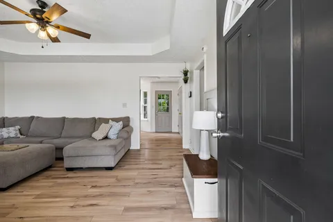 a living room with furniture and a walk in closet
