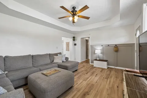a living room with furniture and wooden floor