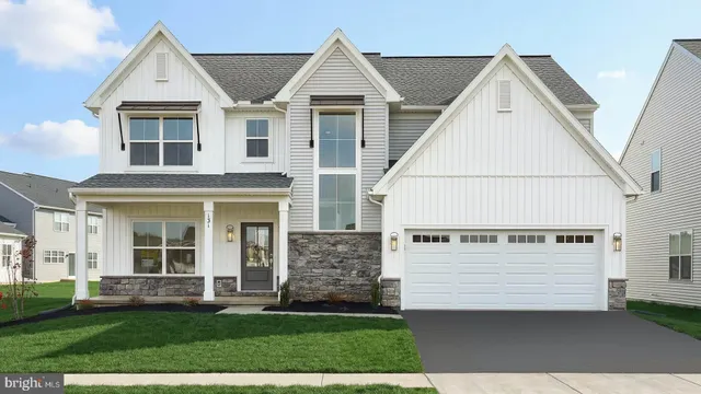 a view of a white house with yard and plants