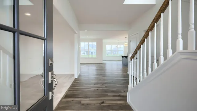 a view of an entryway with wooden floor