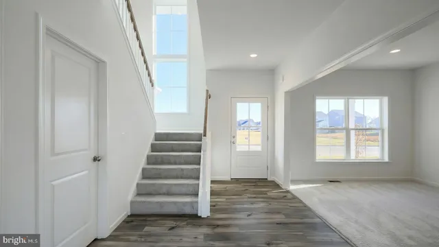 an empty room with windows and entryway