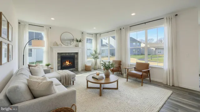 a living room with furniture dining table and a fireplace