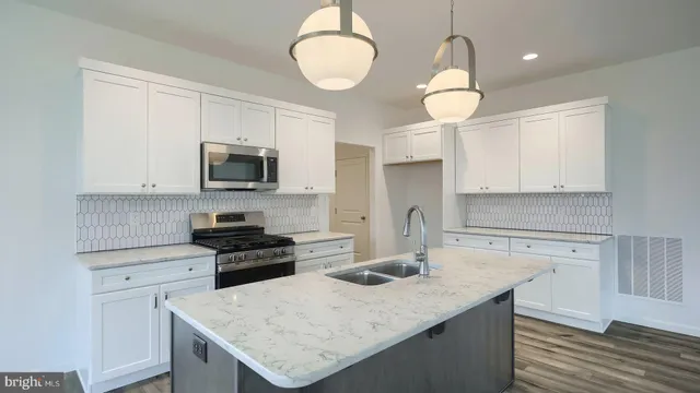 a kitchen with a sink a stove a microwave and cabinets